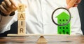 Wooden blocks with the word Fair and a wooden house. Fair value of real estate and housing. Property valuation. Home appraisal.