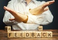 Wooden blocks with the word Feedback and critic. The concept of the bad rating of hotels and restaurants. The evaluation of