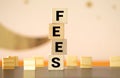 Wooden blocks with the word Fees and randomly scattered cubes. FEES Royalty Free Stock Photo