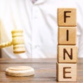 Wooden blocks with the word Fine and judge. Penalty as a punishment for a crime and offense. Financial punishment. Violations of