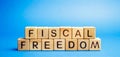 Wooden blocks with the word Fiscal freedom. Tax burden imposed by government. Taxation. Taxes concept. Business and Finance