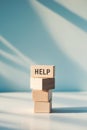 Wooden blocks with the word help on a blue background. Royalty Free Stock Photo