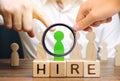 Wooden blocks with the word Hire. Headhunter selects a person from the crowd. Good choice. Human Resource Management. Recruiting Royalty Free Stock Photo