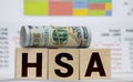 Wooden blocks with the word HSA and money bag with stethoscope. Health savings account. Health care. Health insurance. Investments Royalty Free Stock Photo