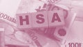 Wooden blocks with the word HSA standing for Health savings account put on 100 Euro bills. Healthcare, life insurance Royalty Free Stock Photo