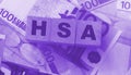 Wooden blocks with the word HSA standing for Health savings account put on 100 Euro bills. Healthcare, life insurance Royalty Free Stock Photo