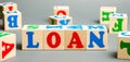 Wooden blocks with the word Loan. Consumer, banking and property loan. Business and entrepreneurial development. Small business