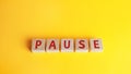 Wooden blocks with the word Pause. Break time concept. A break during work. Time to relax and recharge. Stop the business process