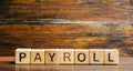 Wooden blocks with the word Payroll. Payroll is the sum total of all compensation a business must pay to its employees for a set