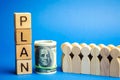 Wooden blocks with the word Plan and a business team standing next to money. Strategy planning. Management business concept.