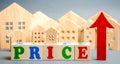 Wooden blocks with the word Price, up arrow and wooden houses. The concept of raising property prices. High cost for rental Royalty Free Stock Photo