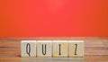 Wooden blocks with the word Quiz. Business or education concept. Answers to oral or written questions from various fields of