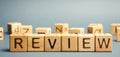 Wooden blocks with the word Review. Customer review concept. Reviewing, auditing, reviewer. Service rating. Feedback Royalty Free Stock Photo