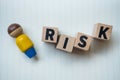 Wooden blocks with the word RISK and leader. Business concept of crisis solution and problem management Royalty Free Stock Photo