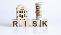 Wooden blocks with the word For RISK Real estate concept. Rent apartment