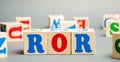 Wooden blocks with the word ROR. Ratio between the net profit and cost of investment resulting from an investment of resources. Royalty Free Stock Photo