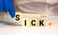 Wooden blocks with the word Sick. Medical concept