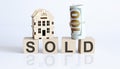 Wooden blocks with the word For SOLD Real estate concept. Rent apartment