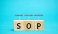Wooden blocks with the word SOP Standard operating procedure . Instructions to assist employees in complex routine operations.
