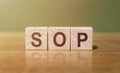 Wooden blocks with the word SOP - Standard operating procedure. Instructions to assist employees in complex routine operations. Royalty Free Stock Photo