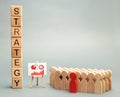 Wooden blocks with the word Strategy, business schedule and team of employees. Business strategy is an integrated model of actions