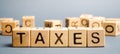 Wooden blocks with the word Taxes. Business and finance concept. Tax and taxation. The tax burden Royalty Free Stock Photo