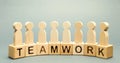 Wooden blocks with the word Teamwork and business team of employees. The concept of cooperation. Constructive feedback. Joint Royalty Free Stock Photo