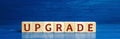 Wooden blocks with the word Upgrade. Improvement, modernization and renewal concept. Upgrading software or hardware to a more