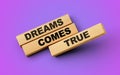 Wooden blocks with the words Dreams Come True. 3d illustration