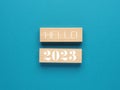 Wooden blocks with the words hello 2023 on blue