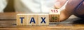 Wooden blocks with the words Tax, yes or no. Taxes payment concept. Tax evasion. Taxation. Business and finance. Choose, make a Royalty Free Stock Photo