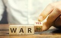 Wooden blocks with the words War, yes and no. Conflict between political states and factions. Armed confrontation, military and Royalty Free Stock Photo