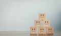 A wooden blog on customer service assessment concepts and satisfaction surveys. The customer selects a smiley face icon