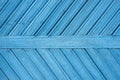 Wooden blue background with old blue paint and boards diagonally