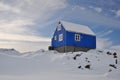 Wooden blue cabin in winter