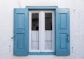 Wooden blue color window on a whitewashed wall. Greece, Cyclades Royalty Free Stock Photo