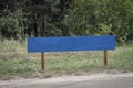 Wooden blue tablet on the inscriptions. In the park, Surface for inscription