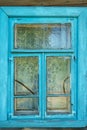 Wooden blue window shutters on the wall of an old dilapidated wooden house in the village. The destroyed abandoned dwelling after Royalty Free Stock Photo