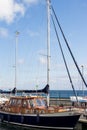 Wooden blue yacht stands near the pier