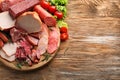 Wooden board with assortment of delicious deli meats on wooden board Royalty Free Stock Photo