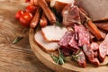 Wooden board with assortment of delicious deli meats on wooden board Royalty Free Stock Photo