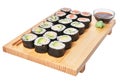 Wooden board with avocado, salmon and cucumber sushi makis isolated on white background Royalty Free Stock Photo