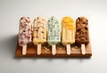 Homemade ice creams with different toppings on a wooden board