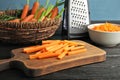 Wooden board with carrot sticks Royalty Free Stock Photo