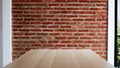 Wooden board empty table with a background of bricks Royalty Free Stock Photo