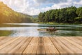 Wooden board empty table blur lake in forest background. Royalty Free Stock Photo