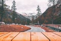 Wooden board empty table in front of blurred background. Perspective brown wood over road in pine trees forest for mock up Royalty Free Stock Photo