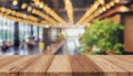 Wooden board empty table in front of blurred background. Perspective brown wood over blur in coffee shop - can be used for display Royalty Free Stock Photo