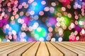 Wooden board empty table in front of colorful blurred background. Perspective brown wood over bokeh light Royalty Free Stock Photo
