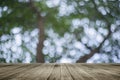 Wooden board empty table in front of natural blurred background. Perspective brown wood over bokeh of tree